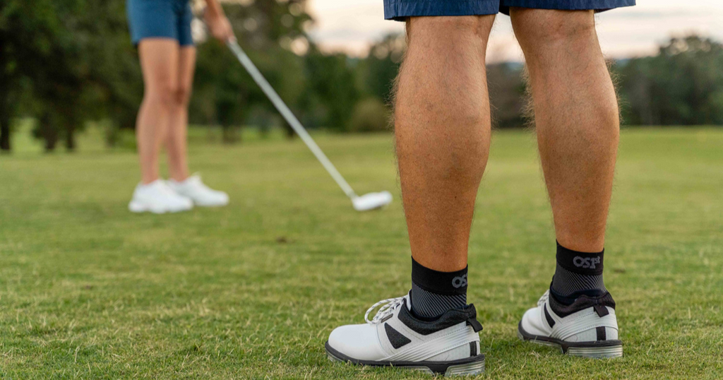 Man wearing the OrthoSleeve Plantar Fasciitis Foot Sleeves while playing golf.