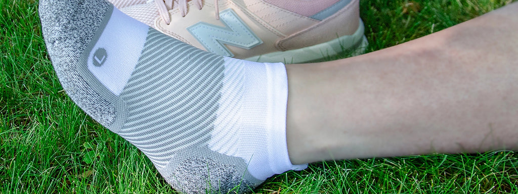 Close up of a persons feet wearing the wellness care no show socks