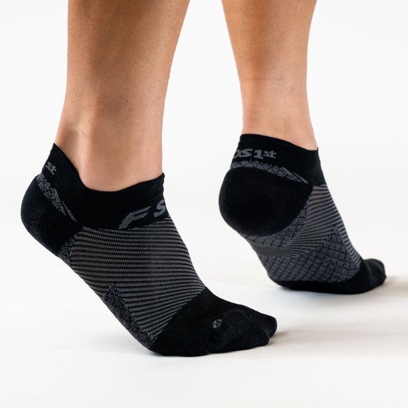Person wearing the OrthoSleeve black no show plantar fasciitis socks