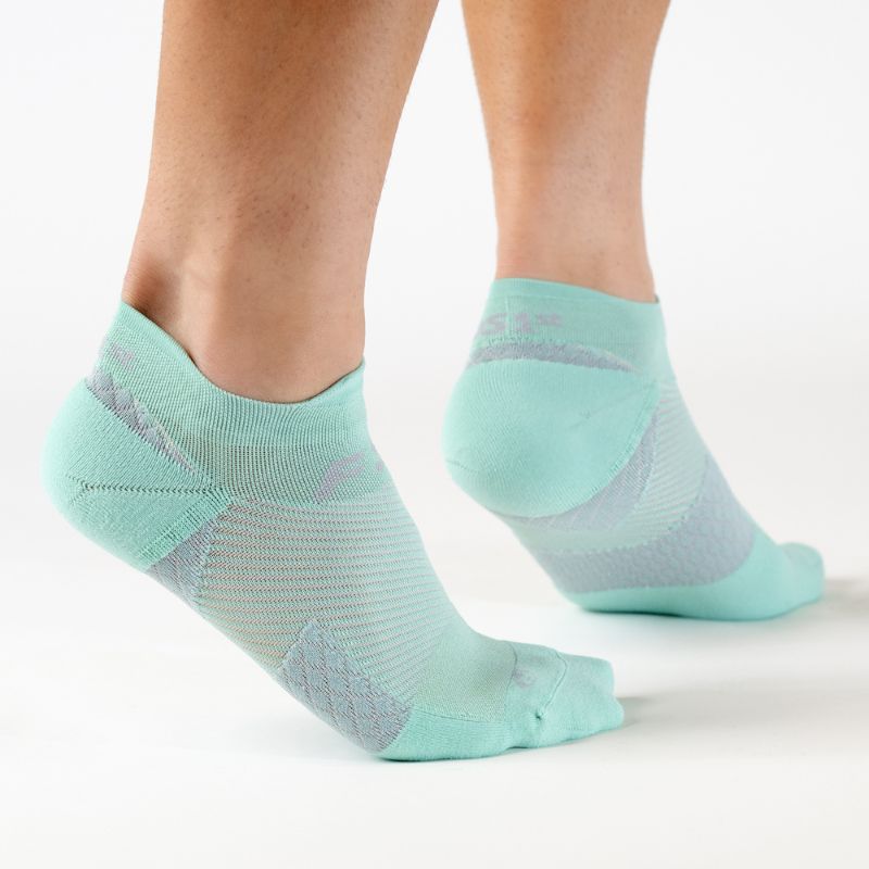Person wearing the OrthoSleeve mint no show plantar fasciitis socks