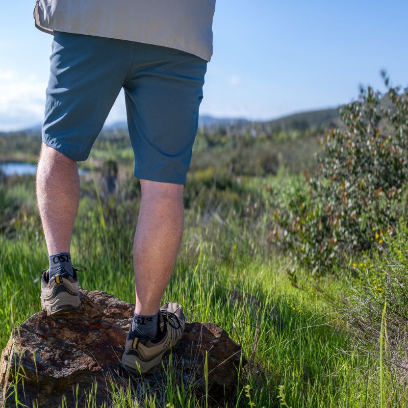 Man wearing the grey quarter crew OrthoSleeve Plantar Fasciitis Socks while hiking