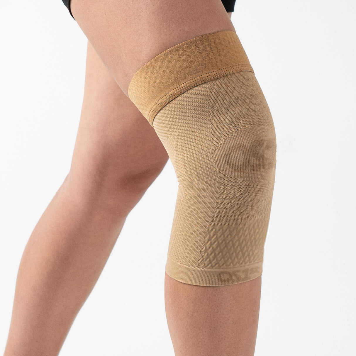 Person wearing the tan OrthoSleeve KS7 Knee Sleeve