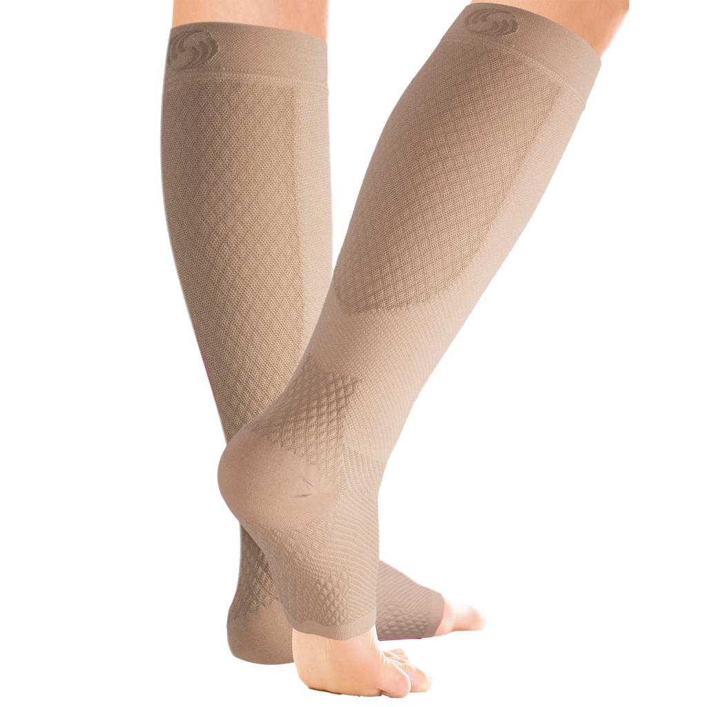 Close up of the tan compression leg sleeves on women's legs