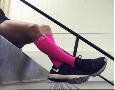 Up close image of a persons legs who is wearing our compression socks and sitting on the stairs