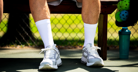 Man wearing the OrthoSleeve Plantar Fasciitis Socks while playing pickleball