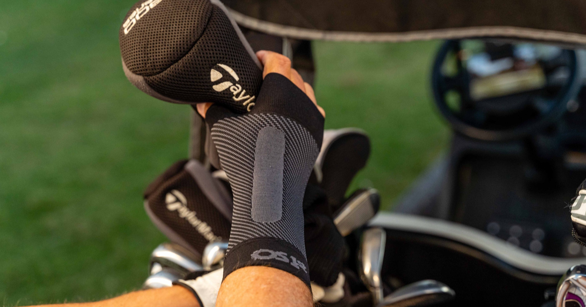 Golfer wearing the OrthoSleeve Compression Wrist Sleeve 
