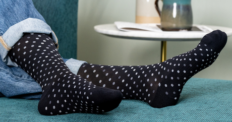 Person wearing the black polka dotted OrthoSleeve Medical Grade Compression Socks