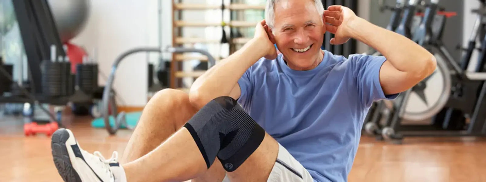 A happy man working out on a mat in the floor