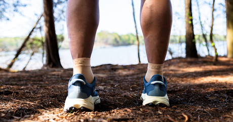 Man hiking while wearing the tan OrthoSleeve FS6 Foot Sleeves