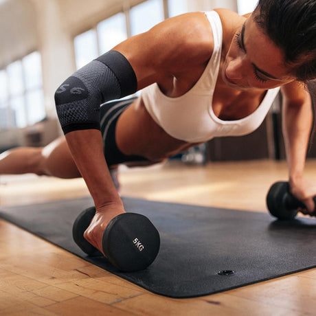 A fit woman working out with weights 