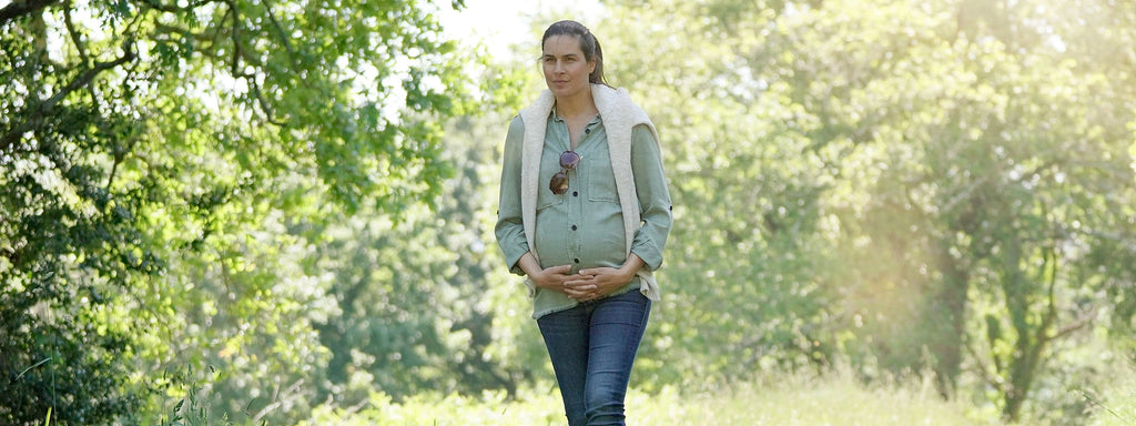 A pregnant woman walking in nature