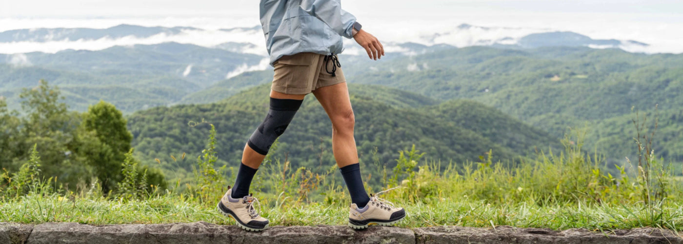 Person wearing OrthoSleeve compression bracing while hiking