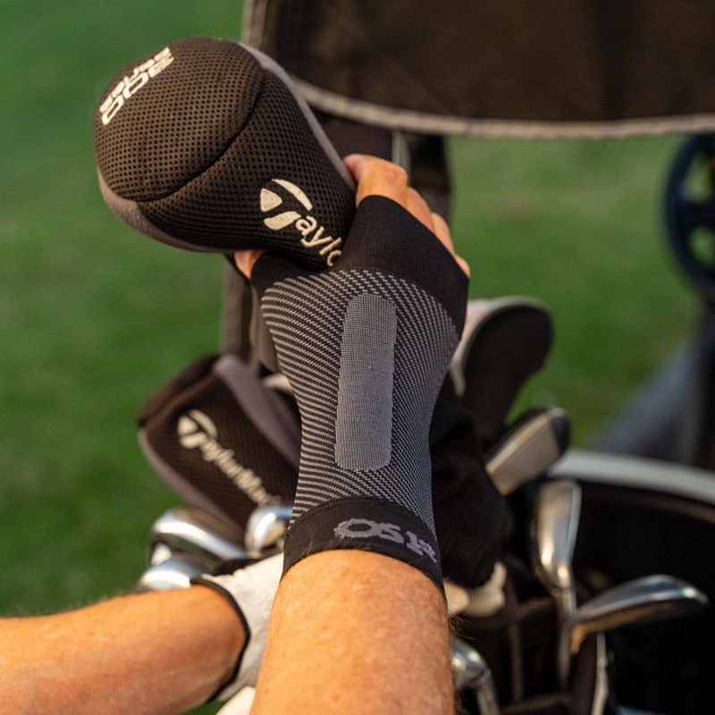 Man wearing the OrthoSleeve Compression Wrist Sleeve while golfing