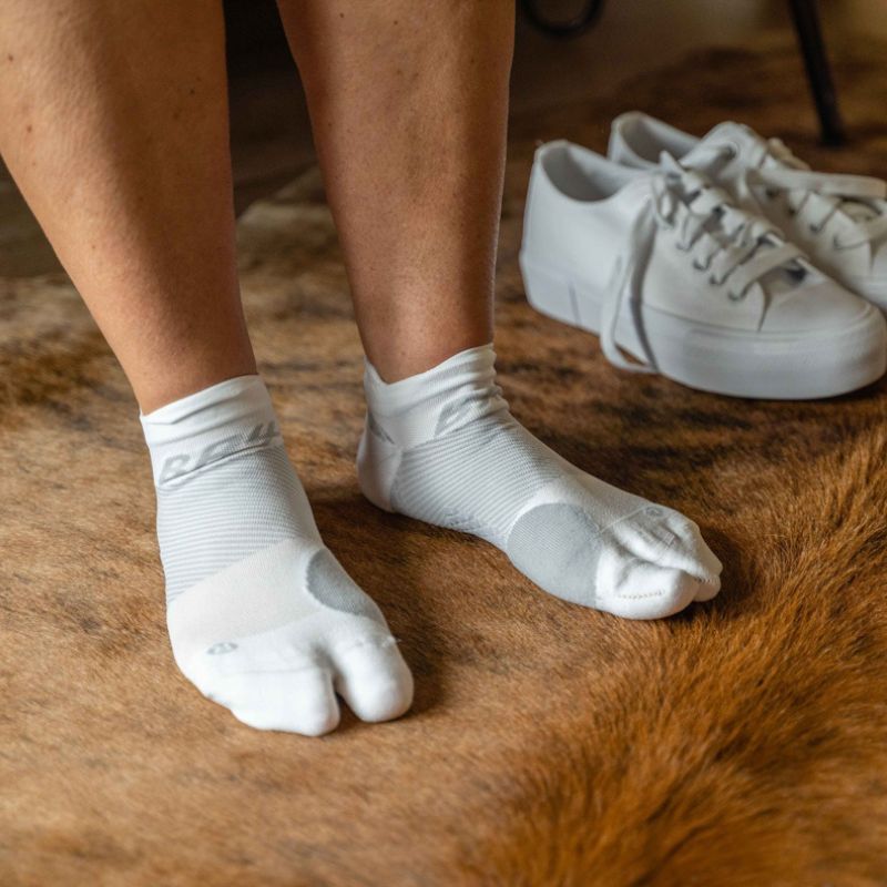 Woman wearing a pair of white OrthoSleeve Bunion Relief Socks