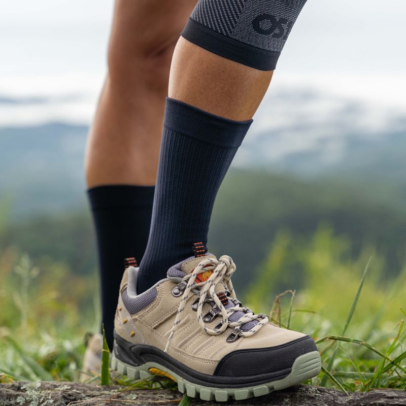 Woman wearing the crew length OrthoSleeve Wellness Care Socks while hiking