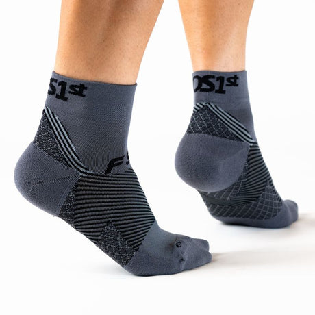 Person wearing the OrthoSleeve charcoal quarter crew length plantar fasciitis socks