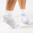 Person wearing the OrthoSleeve white quarter crew length plantar fasciitis socks