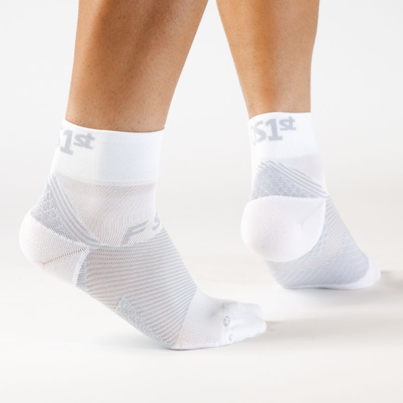Person wearing the OrthoSleeve white quarter crew length plantar fasciitis socks