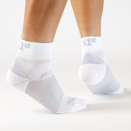 Person wearing the OrthoSleeve white quarter crew length plantar fasciitis socks
