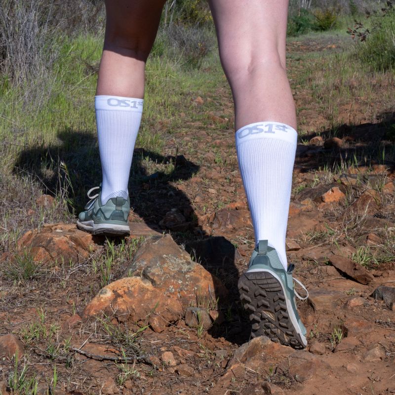 Person wearing the OrthoSleeve Plantar Fasciitis Crew Socks in white while hiking