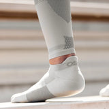 athlete wearing grey thin air performance socks and sleeves | OS1st