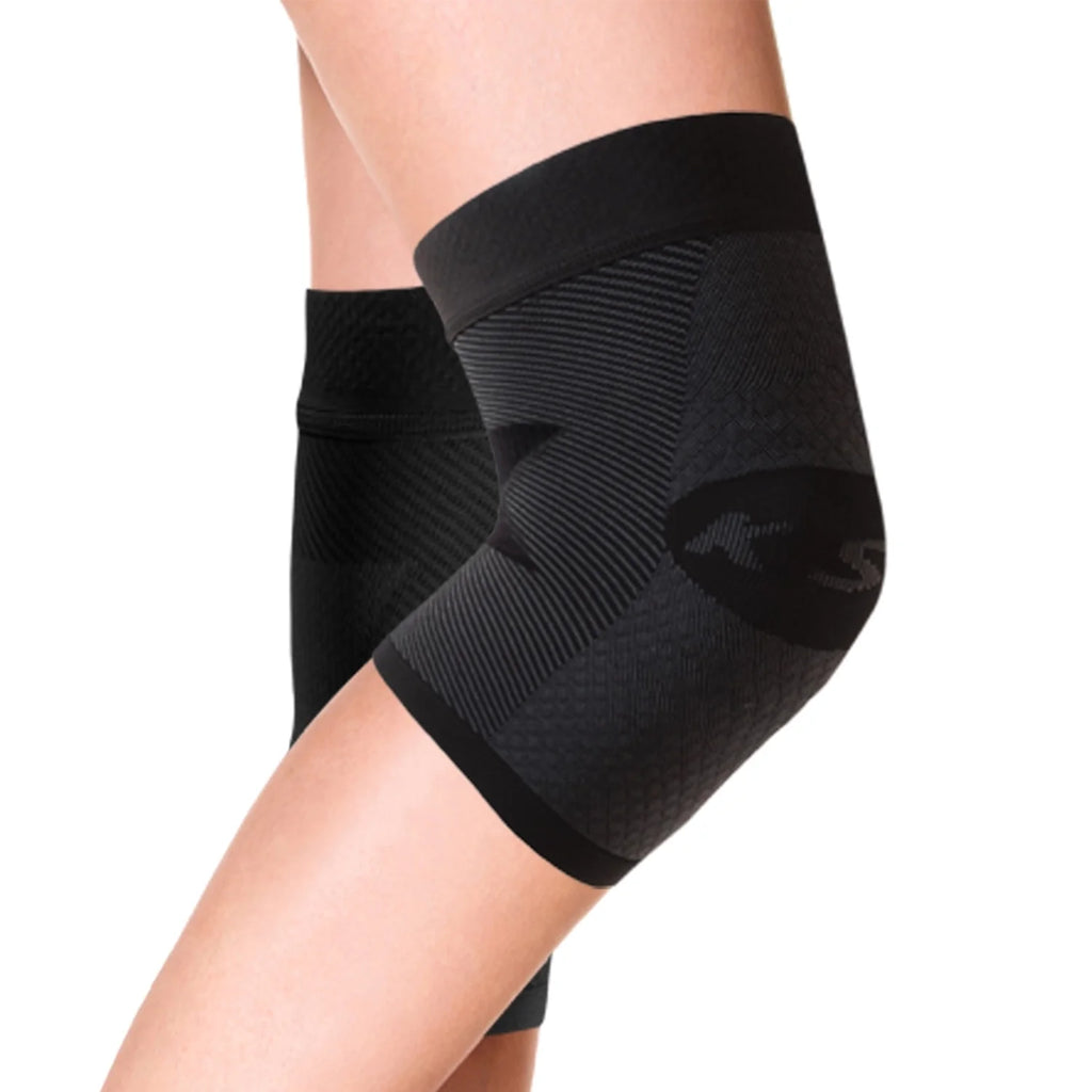 Product image of a pair of black, compression knee braces on women's legs