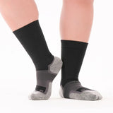 Person wearing the OrthoSleeve Wide Wellness Compression Socks in black crew
