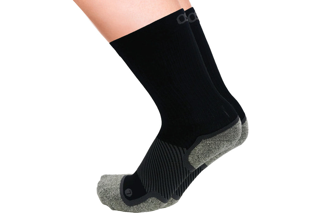 A pair of the wide crew wellness care socks in black