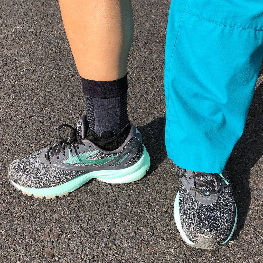 Image of a person in scrubs wearing the ankle brace