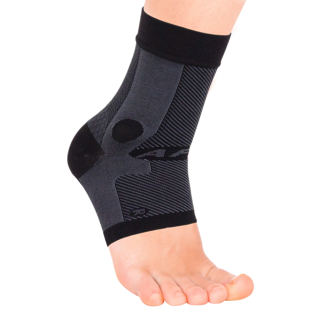 Close up of the black compression ankle sleeve on a model foot