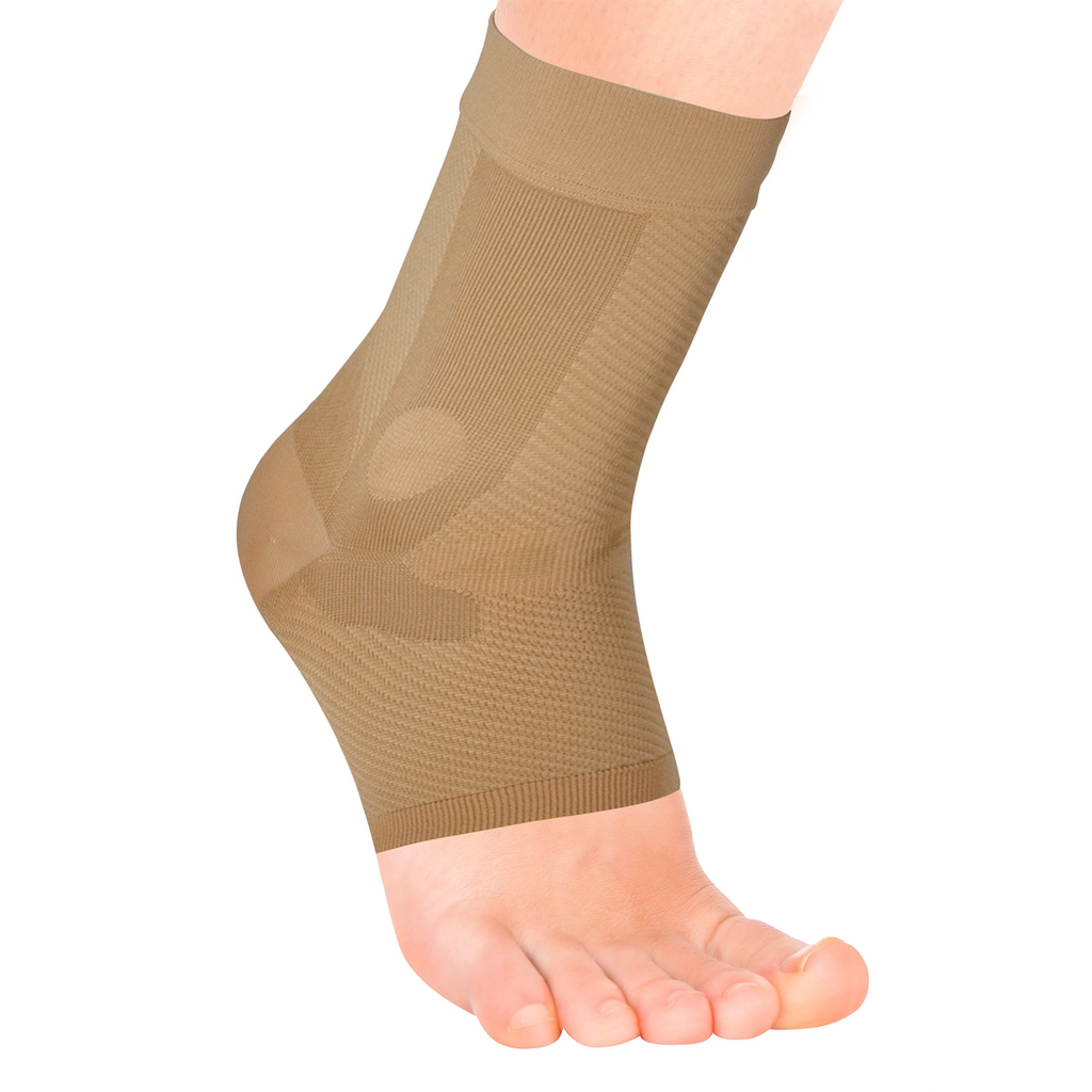 Close up of the tan compression ankle sleeve on a model foot