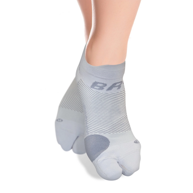 Product image of grey split-toe bunion socks on a woman's feet