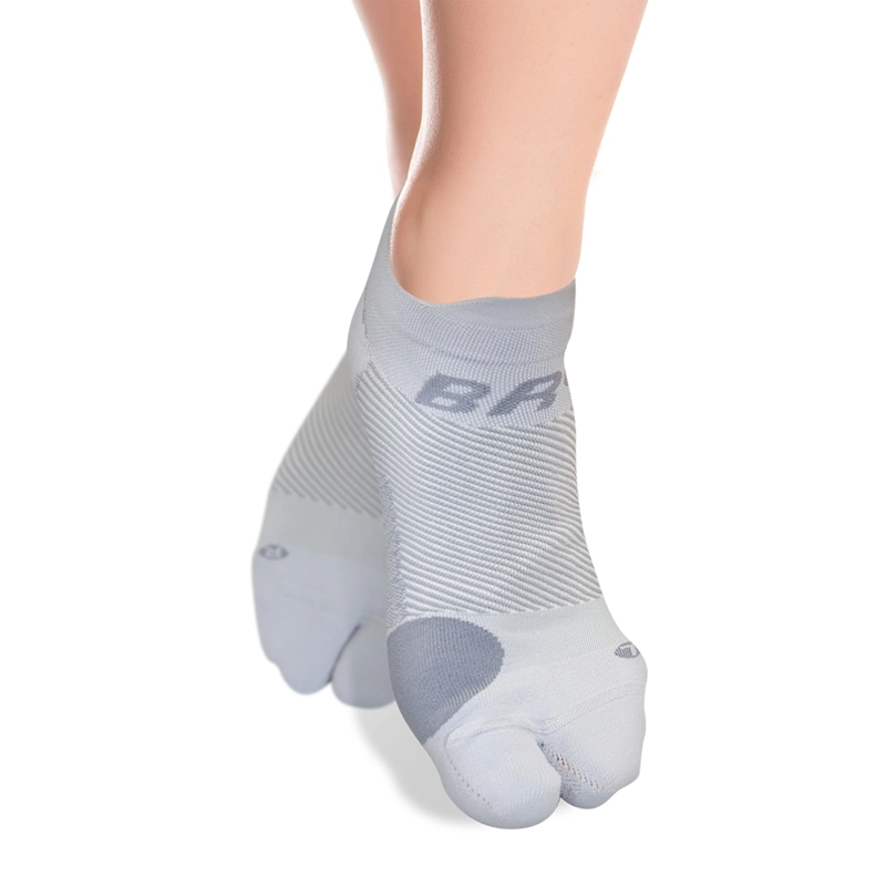 Product image of grey split-toe bunion socks on a woman's feet