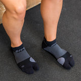 Close up image of a woman wearing the split-toe bunion socks while at the gym