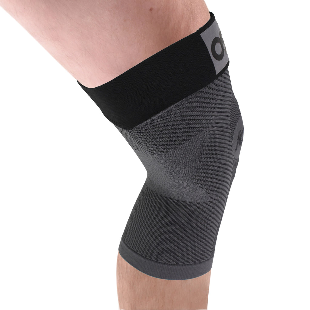A man's leg wearing the adjustable knee sleeve