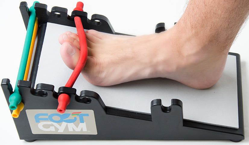 man using the tow flex on the foot gym